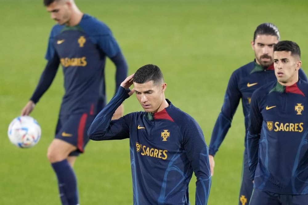 Cristiano Ronaldo, center, scratches his head during a Portugal soccer team training in Oeiras, outside Lisbon, Monday, Nov. 14, 2022. Portugal will play Nigeria Thursday in a friendly match in Lisbon before departing to Qatar on Friday for the World Cup. (AP Photo/Armando Franca)