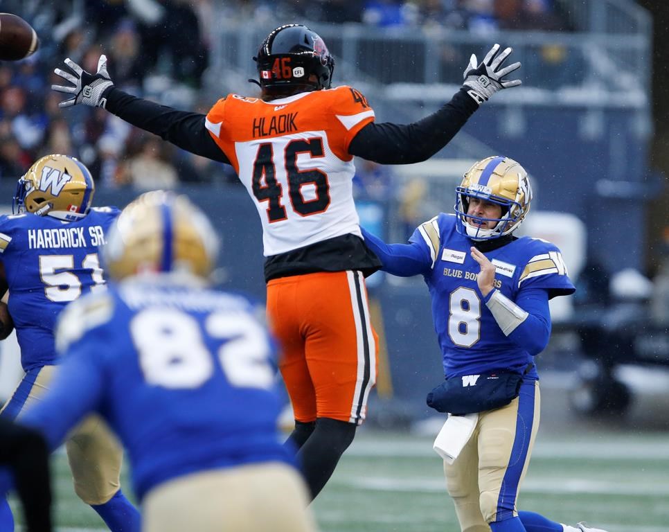 Winnipeg Blue Bombers quarterback Zach Collaros (8) throws with pressure from BC Lions' Ben Hladik (46) during the first half of CFL western final action in Winnipeg, Sunday, Nov. 13, 2022. THE CANADIAN PRESS/John Woods