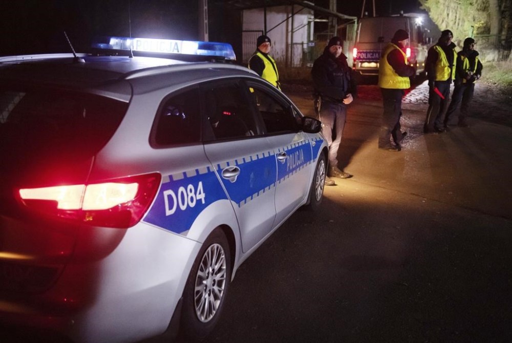 Police officers gather outside a grain depot in Przewodow, eastern Poland, on Tuesday Nov. 15, 2022 where the Polish Foreign Ministry said that a Russian-made missile fell and killed two people. The ministry said Foreign Minister Zbigniew Rau summoned the Russian ambassador and