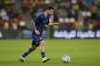 Argentina's Lionel Messi warms up before a friendly soccer match between Argentina and United Arab Emirates in Abu Dhabi, Wednesday, Nov. 16, 2022. (AP Photo/Kamran Jebreili)