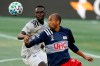 Montreal Impact's Karifa Yao, left, and New England Revolution's Teal Bunbury, right, keep their eyes on the ball during the first half of an MLS soccer match, Wednesday, Sept. 23, 2020, in Foxborough, Mass. The Vancouver Whitecaps picked up Canadian defender Yao in Major League Soccer's re-entry draft on Thursday.THE CANADIAN PRESS/AP-Steven Senne