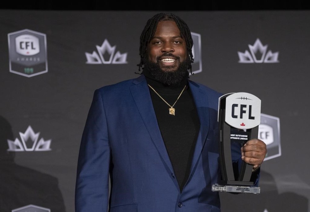 Most outstanding offensive lineman, Stanley Bryant of the Winnipeg Blue Bombers, holds up his trophy during the CFL Awards in Regina, Thursday, Nov. 17, 2022. THE CANADIAN PRESS/Paul Chiasson