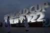 People pose for a photograph with a FIFA World Cup sign in Doha, Qatar, Thursday, Nov. 17, 2022. The day after its win over Japan in Dubai in its final World Cup warmup, Canada had no media availability Friday — leaving time to recover, assess and prepare for Wednesday's tournament opener against second-ranked Belgium. But while Canada laid low, the World Cup was hard to miss in downtown Doha. THE CANADIAN PRESS/AP/Hassan Ammar