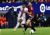 Barcelona's Alejandro Balde, left, challenges for the ball with Osasuna's Jon Moncayola during a Spanish La Liga soccer match between Osasuna and Barcelona at El Sadar stadium in Pamplona, Spain, Tuesday, Nov. 8, 2022. (AP Photo/Alvaro Barrientos)