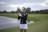 Nelly Korda holds the championship trophy after winning the LPGA Pelican Women's Championship golf tournament at Pelican Golf Club, Sunday, Nov. 13, 2022, in Belleair, Fla. (AP Photo/Phelan M. Ebenhack)