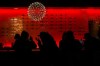 People are silhouetted as they sit in a bar having a drink in Toronto on Wednesday, March 30, 2022. Ontario's liquor regulator says restaurants and bars provincewide will be able to serve alcohol at 7 a.m. for the duration of the FIFA World Cup to align with some of the early-morning matches. THE CANADIAN PRESS/Nathan Denette