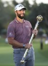 Jon Rahm of Spain holds the trophy after winning DP World Tour Championship in Dubai, United Arab Emirates, Sunday, Nov. 20, 2022. (AP Photo/Martin Dokoupil)