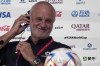 Australia's head coach Graham Arnold adjusts his headphone during a press conference on the eve of the group D World Cup soccer match between France and Australia, in Doha, Qatar, Monday, Nov. 21, 2022. (AP Photo/Ariel Schalit)
