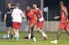 Canada star Alphonso Davies, centre, grimaces during a warmup drill at the World Cup in Doha, Qatar during on Monday, November 21, 2022. THE CANADIAN PRESS/Nathan Denette