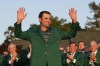 FILE - Scottie Scheffler celebrates after putting on the green jacket after winning the 86th Masters golf tournament on Sunday, April 10, 2022, in Augusta, Ga. Scheffler's year of four wins is easy to overlook because his last win was in April.(AP Photo/David J. Phillip, File)