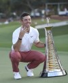 Rory McIlroy of Northern Ireland is posing with the trophy for his fourth win of the DP World Tour season after finishing fourth in DP World Tour Championship in Dubai, United Arab Emirates, Sunday, Nov. 20, 2022. (AP Photo/Martin Dokoupil)