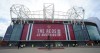 FILE - Security and stewards stand outside the Old Trafford stadium in Manchester, England, Tuesday, May 11, 2021 ahead of the English Premier League soccer match between Manchester United and Leicester City. Manchester United's American owners confirmed Tuesday, Nov. 22, 2022, they would consider putting the iconic Premier League club up for sale. United said the Glazer family was exploring outside funding to enhance growth — a move that could pave the way to a potential buyout. (AP Photo/Jon Super, FIle)