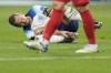 England's Harry Kane grabs his foot after a collision with Iran's Morteza Pouraliganji during the World Cup group B soccer match between England and Iran at the Khalifa International Stadium in Doha, Qatar, Monday, Nov. 21, 2022. (AP Photo/Abbie Parr)