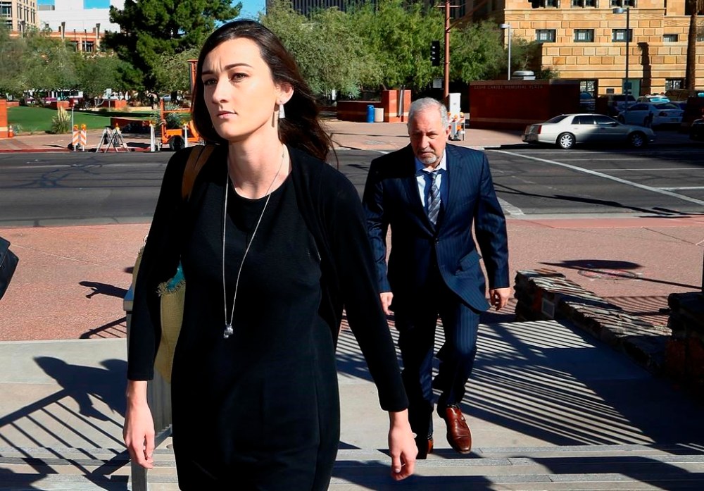 FILE - Laney Sweet, left, widow of Daniel Shaver, arrives Oct. 25, 2017, at Maricopa County, Ariz., Superior Court in Phoenix with attorney Mark Geragos, right, for opening statements in the trial of former Mesa, Ariz., Police Officer Philip Brailsford, charged with murder in the fatal 2016 shooting of the unarmed Shaver. On Tuesday, Nov. 22, 2022, Sweet agreed to settle her wrongful death lawsuit. A notice of settlement filed in federal court in Arizona shows that Sweet and her two children will receive $8 million from the city of Mesa. (AP Photo/Ross D. Franklin, File)