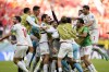 Iran's Rouzbeh Cheshmi, not seen, celebrates scoring the opening goal with teammates during the World Cup group B soccer match between Wales and Iran, at the Ahmad Bin Ali Stadium in Al Rayyan , Qatar, Friday, Nov. 25, 2022. (AP Photo/Francisco Seco)