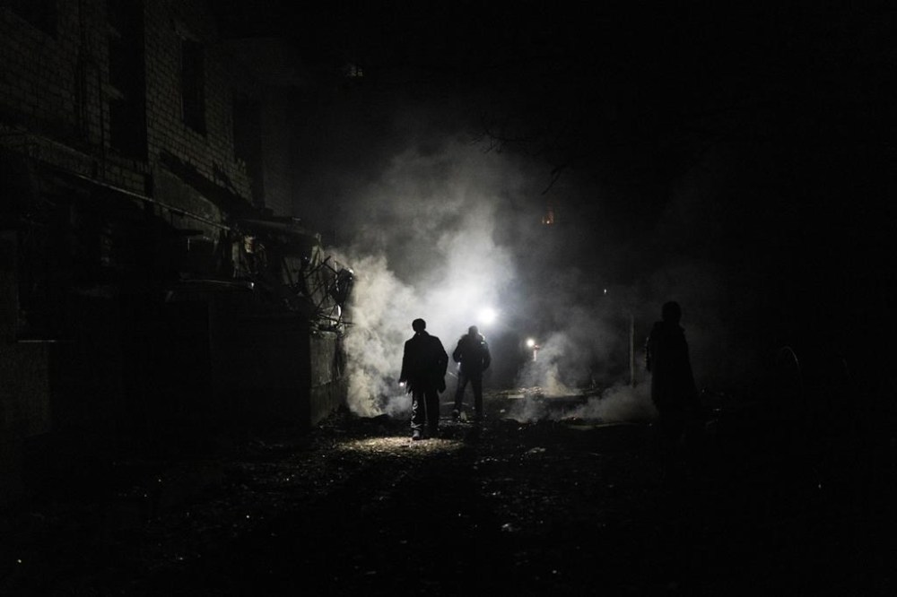 A resident walks amid debris after a Russian attack in Kherson, southern Ukraine, Thursday, Nov. 24, 2022. (AP Photo/Bernat Armangue)