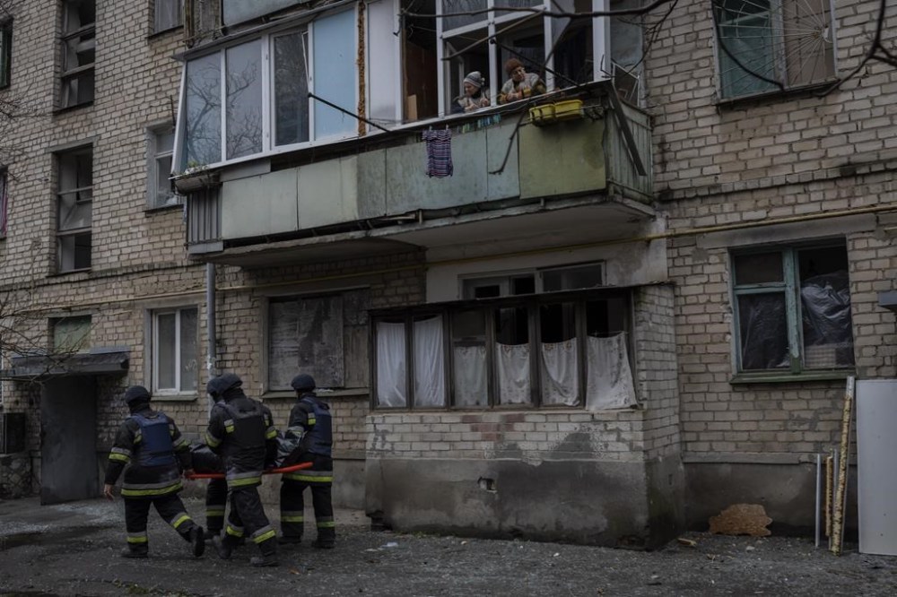 City responders carry the dead body of Natalia Kristenko, 62, in Kherson, southern Ukraine, Friday, Nov. 25, 2022. Natalia Kristenko had walked outside her home with her husband Thursday evening after drinking tea when the building was struck. Kristenko was killed instantly from a wound to the head. Her husband died hours later in the hospital from internal bleeding. (AP Photo/Bernat Armangue)