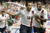 FILE - USA's Landon Donovan, left, celebrates with DaMarcus Beasley after scoring a penalty kick against Mexico during the second half of the Gold Cup Soccer game, Sunday, June 24, 2007, in Chicago. Donovan and Beasley were elected Saturday, Nov. 26, 2022, to the U.S. National Soccer Hall of Fame and will be inducted May 6 along with Lauren Cheney Holiday.(AP Photo/Nam Y. Huh, File)