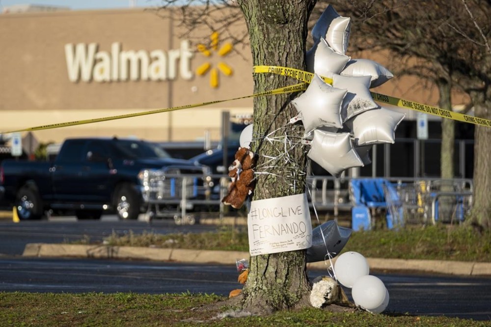 Balloon and a Teddy bear adorn a memorial for teenager Fernando Chavez-Barron, Friday, Nov. 25, 2022 , one of six killed in a Chesapeake, Va., Walmart mass shooting earlier in the week. (Billy Schuerman/The Virginian-Pilot via AP)