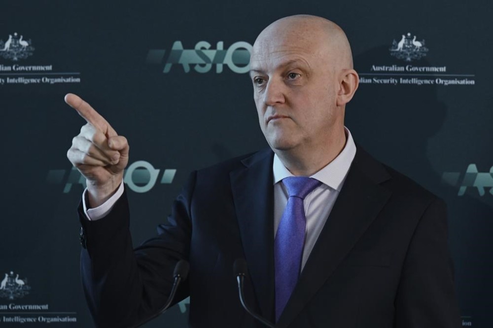 Australian Security Intelligence Organization director-general Mike Burgess points as he talks in Canberra, Australia, Monday, Nov. 28, 2022. Australia’s terrorism threat level has been downgraded from “probable
