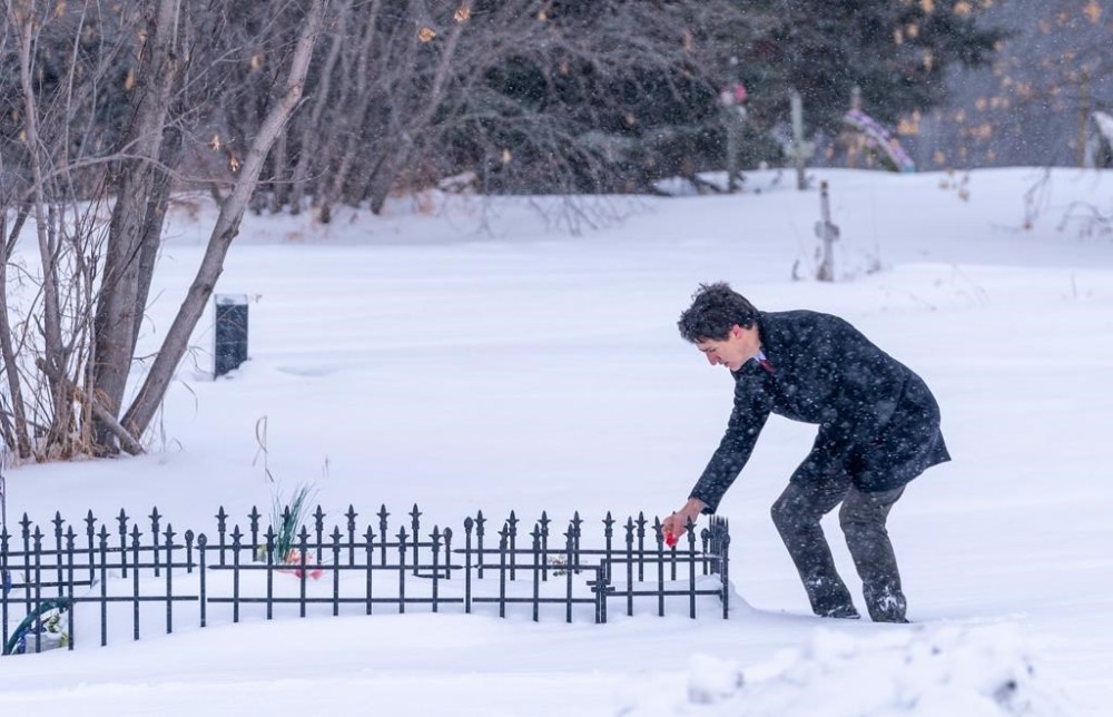Prime Minister Justin Trudeau lays tobacco in front of a grave of one of the victims of a mass stabbing at James Smith Cree Nation, Sask., on Monday, Nov. 28, 2022. THE CANADIAN PRESS/Heywood Yu