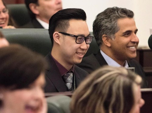 Edmonton-Southwest MLA Thomas Dang, 20, laughs along with his colleagues during an introductory meeting with all newly elected MLAs in Edmonton, on Tuesday, May 12, 2015. THE CANADIAN PRESS/Amber Bracken