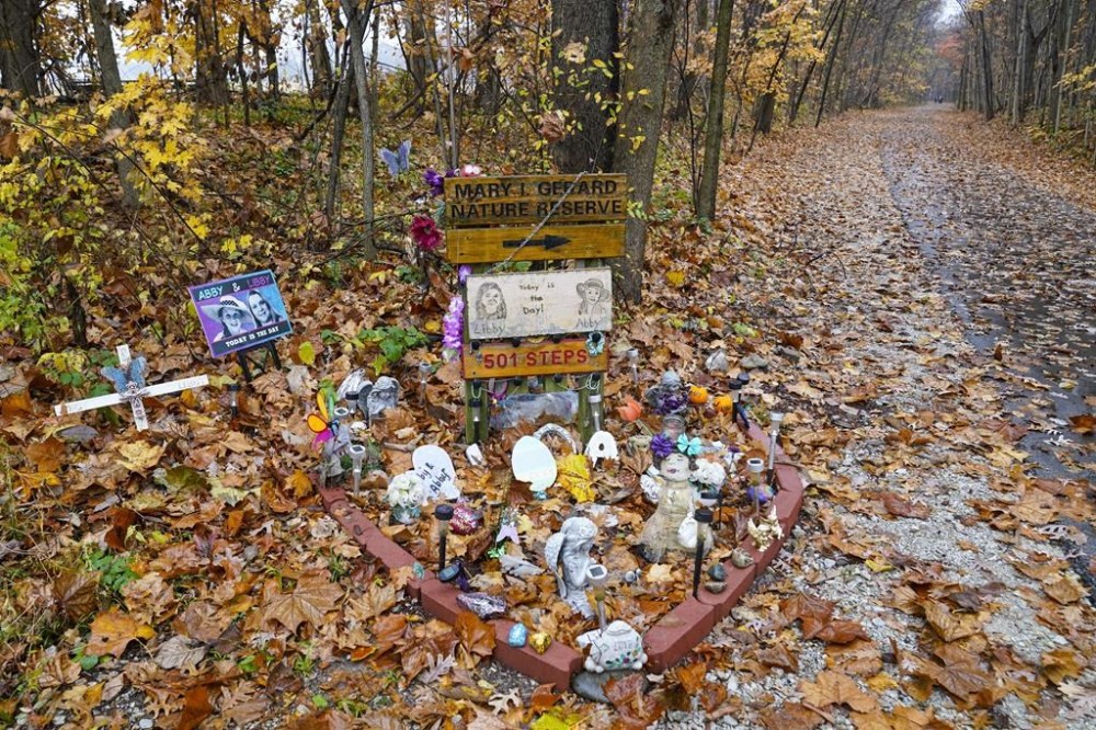 FILE - A makeshift memorial to Liberty German and Abigail Williams is pictured near where they were last seen and where the bodies were discovered along the Monon Trail leading to the Monon High Bridge Trail in Delphi, Ind., Oct. 31, 2022. Documents related to a man’s arrest in the 2017 killings of two teenage girls were unsealed Tuesday, Nov. 29, 2022 by an Indiana judge, allowing for the first public disclosure of evidence authorities have against the suspect since he was arrested last month. (AP Photo/Michael Conroy, File)