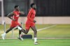 Canada forward Alphonso Davies, right, runs with teammate Jonathan David during practice at the World Cup in Doha, Qatar, on Tuesday, Nov. 29, 2022. THE CANADIAN PRESS/Nathan Denette