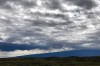 The Mauna Loa volcano is seen erupting in the background near Waimea, Hawaii, on Tuesday, Nov. 29, 2022. Waves of orange, glowing lava and ash blasted and billowed from the world's largest active volcano in its first eruption in 38 years, and officials told people living on Hawaii's Big Island to be ready in the event of a worst-case scenario. (AP Photo/Caleb Jones)