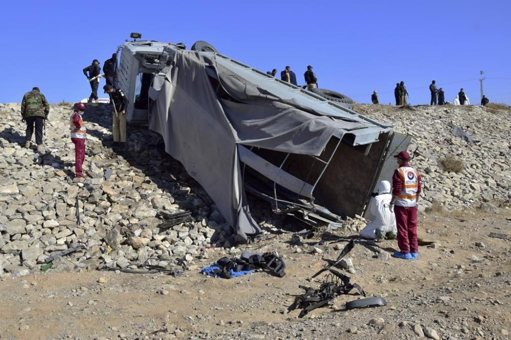 Pakistani security officials inspect at damaged truck at the site of suicide bombing on the outskirts of Quetta, Pakistan, Wednesday, Nov. 30, 2022. A suicide bomber blew himself up near a truck carrying police officers on their way to protect polio workers outside Quetta, wounding more than 20 others, mostly policemen, officials said. (AP Photo/Arshad Butt)