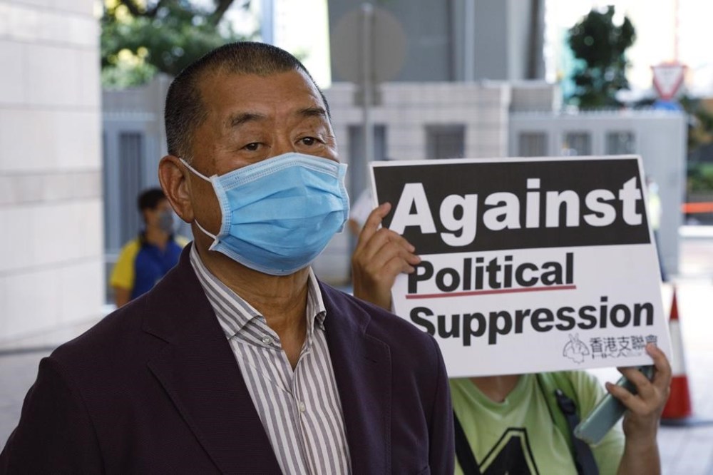 FILE - Hong Kong media tycoon Jimmy Lai, founder of the local newspaper Apple Daily, arrives a district court in Hong Kong, July 30, 2020. Lai broke into the media industry about 30 years ago armed with the belief that delivering information equates with delivering freedom. Lai now is accused of endangering national security with his now-defunct pro-democracy newspaper Apple Daily. (AP Photo/Kin Cheung, File)