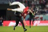 A pitch invader jumps during a World Cup group D soccer match between Tunisia and France at the Education City Stadium in Al Rayyan, Qatar, Wednesday, Nov. 30, 2022. (AP Photo/Martin Meissner)