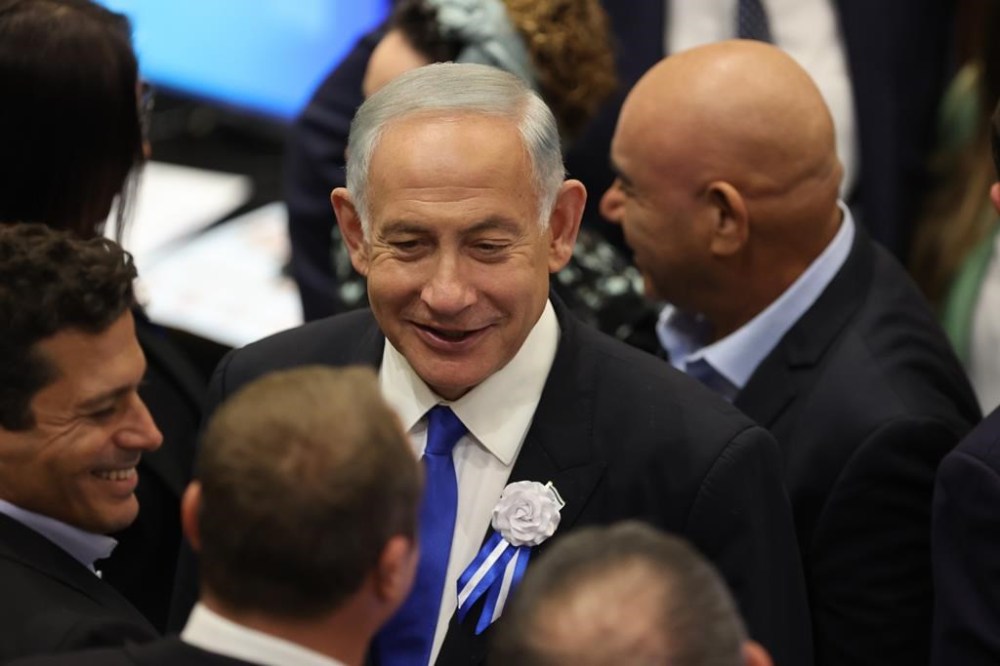 FILE - Israel's Likud Party leader Benjamin Netanyahu arrives for the swearing-in ceremony of Israeli lawmakers at the Knesset, Israel's parliament, in Jerusalem, Nov. 15, 2022. Netanyahu, Israel's designated prime minister, announced on Thursday, Dec. 1, a coalition deal that will give a hardline, pro-settler party control over a number of key government ministries and a senior role in overseeing the construction of Jewish settlements in the occupied West Bank. (Abir Sultan/Pool Photo via AP, File)