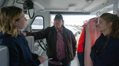 Hubert Nicholas, director of Fisheries at Membertou First Nation speaks with engineers Erica Pineo, left, and Marissa Campbell in a 2022 handout photo. An environmental charity and Membertou First Nation in Nova Scotia are partnering to develop the first generation of electric lobster fishing boats on Canada's east coast. THE CANADIAN PRESS/HO-Ocean North, *MANDATORY CREDIT*