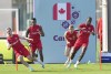Canada forward Liam Millar, left, midfielder Mark-Anthony Kaye, second left, midfielder David Wotherspoon, second right, and forward Ike Ugbo, right, run a drill during practice at the World Cup in Doha, Qatar, Monday, Nov. 28, 2022. The Canadian men leave the World Cup with 