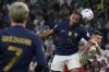 France's Jules Kounde, left, and Poland's Sebastian Szymanski, right, fight for the ball during the World Cup round of 16 soccer match between France and Poland, at the Al Thumama Stadium in Doha, Qatar, Sunday, Dec. 4, 2022. (AP Photo/Natacha Pisarenko)