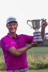 Poland's Adrian Meronk holds up the men's the Australian Open golf championship trophy at Victoria golf course in Melbourne, Australia, Sunday, Dec. 4, 2022. (AP Photo/Asanka Brendon Ratnayake)