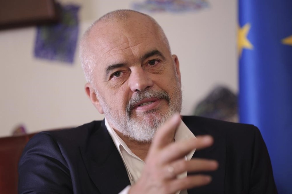 Albania's Prime Minister Edi Rama speaks during an interview with the Associated Press in Tirana, Albania, Monday, Dec. 5, 2022. Rama said Monday that a European Union summit in his country's capital this week demonstrates the EU's geostrategic interests in the Western Balkans region. (AP Photo/Franc Zhurda)