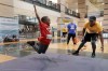 Kids test their diving football catches, one of many sports activities during the Sports Matter Day at the University of Houston, Saturday, Dec. 3, 2022, in Houston. (AP Photo/Michael Wyke)