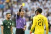 Referee Slavko Vincic of Slovenia, centre, show a yellow card to Saudi Arabia's goalkeeper Mohammed Al-Owais during the World Cup group C soccer match between Argentina and Saudi Arabia at the Lusail Stadium in Lusail, Qatar, Tuesday, Nov. 22, 2022. (AP Photo/Ebrahim Noroozi)