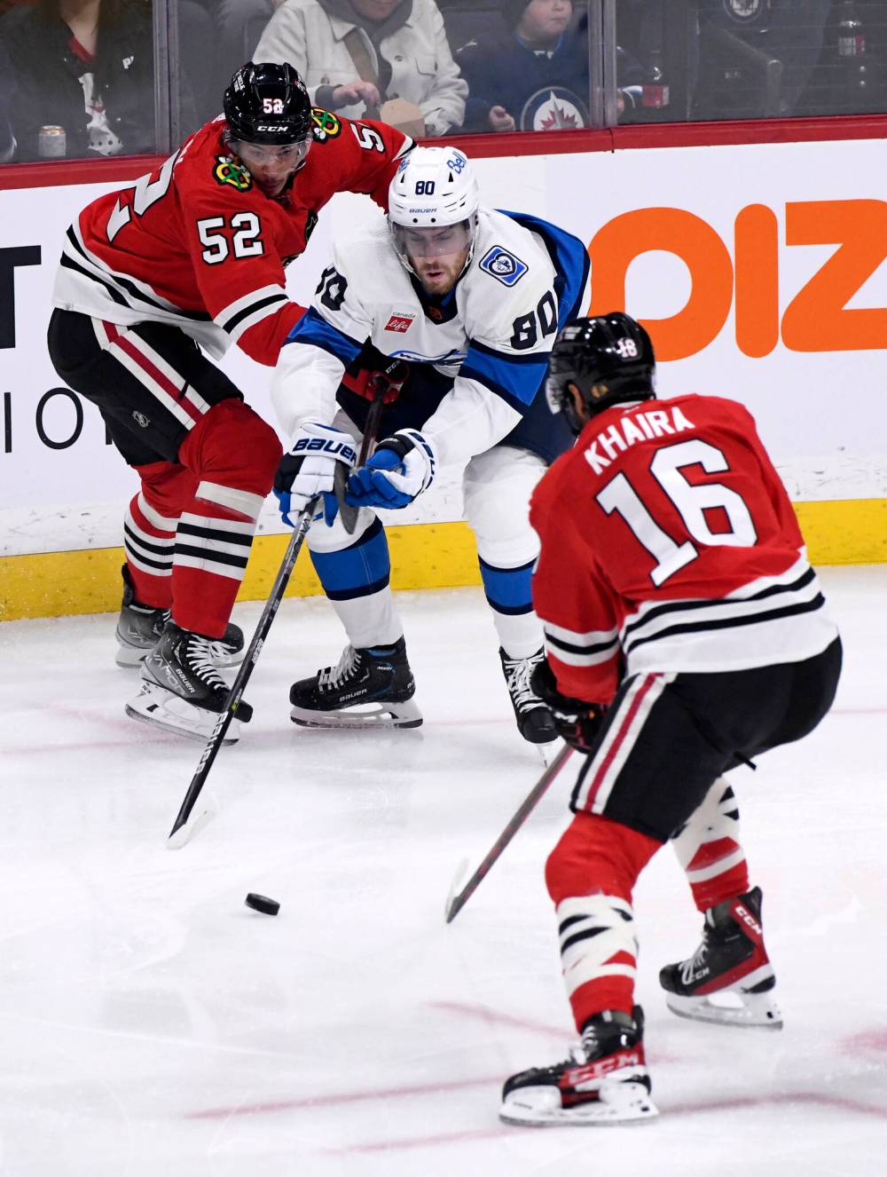 FRED GREENSLADE / THE CANADIAN PRESS
Winnipeg Jets’ Pierre-Luc Dubois (80) battles for the puck against Chicago Blackhawks’ Reese Johnson (42) and Jujhar Khaira (16) during the first period.