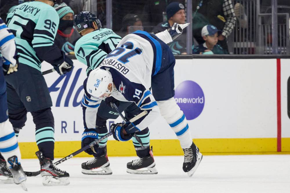 JOHN FROSCHAUER / THE ASSOCIATED PRESS
Winnipeg Jets center David Gustafsson (19) flips over the back of Seattle Krakencenter Jaden Schwartz (17) during the first period.