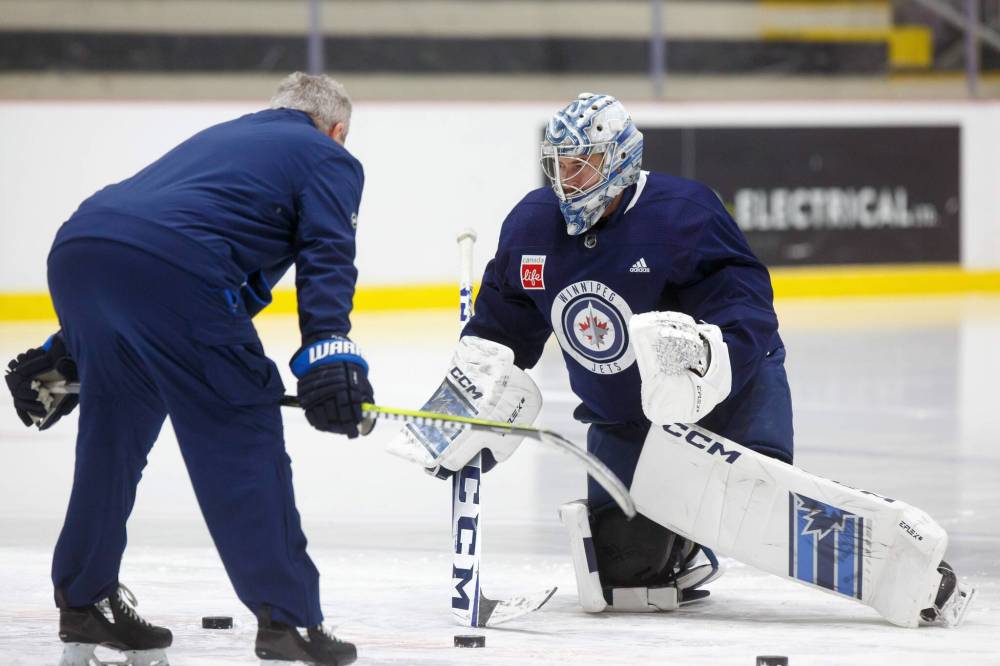 MIKE DEAL / WINNIPEG FREE PRESS
Winnipeg Jets’ goaltender David Rittich works on a drill with assistant coach Wade Flaherty Tuesday during practice.
