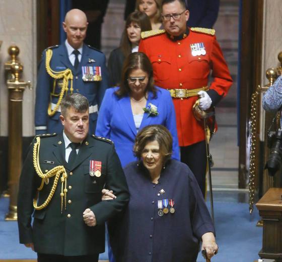 Premier Heather Stefanson (centre) and Lt.-Gov. Anita Neville (front row, right) enter the legislature (Mike Deal / Winnipeg Free Press)