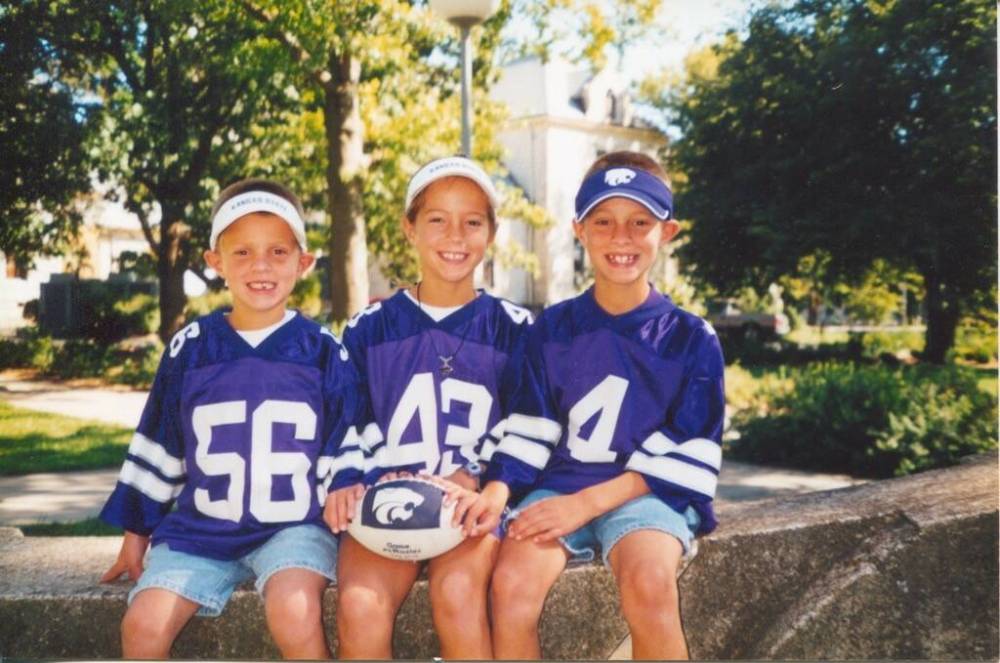 Dalton (left) with his older sister Chandler and his brother Mason would go on family vacations to Kansas State’s football bowl games.. (Supplied)