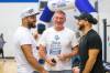 Stu Nixon (centre) greets Nic Demski (left) and Brady Olivera during their visit to Oak Park School with the Grey Cup in May. (Mikaela MacKenzie / Winnipeg Free Press files)