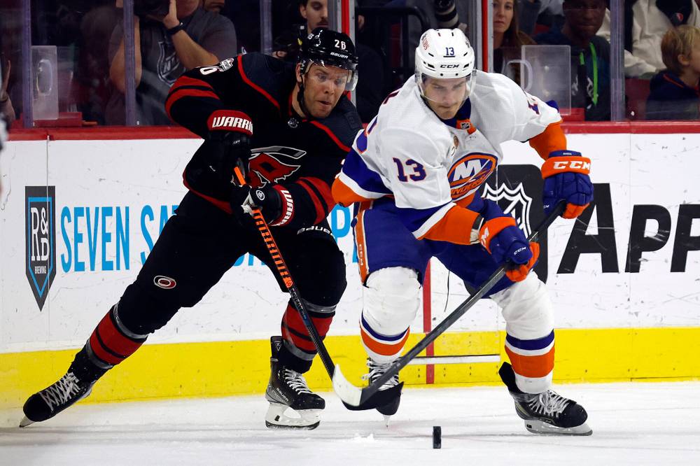 Paul Stastny (left) battles for the puck against New York Islanders Mathew Barzal during the third period of an NHL hockey game in Raleigh, N.C., last month. (Karl B. DeBlaker / Associated Press files)