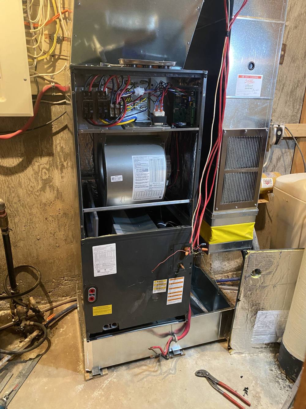 Photos by Marc LaBossiere / Winnipeg Free Press
Unlike a standard electric furnace, the evaporator coil for the A/C unit or heat pump is positioned before the blower, with the heating elements above the blower.