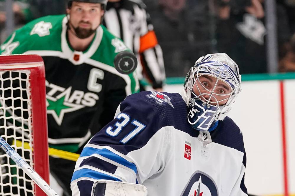 Connor Hellebuyck was without his helmet for four seconds before Dallas scored on Saturday. (LM Otero / The Associated Press)
