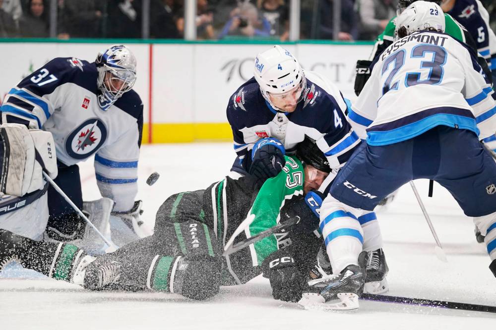 When a goalie loses his helmet, the play should be whistled dead immediately, says Hellebuyck. (LM Otero / The Associated Press)
